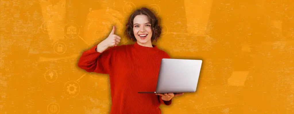 woman smiling holding a laptop